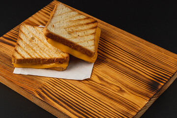 Delicious grilled cheese sandwich served on a wooden platter for lunch