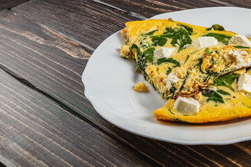 Delicious spinach and feta omelette served on a white plate
