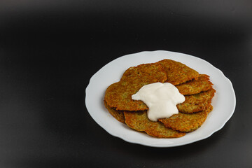 Delicious potato pancakes served with creamy sour cream