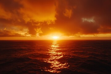 Obraz premium Fiery sunset over the ocean waves, sunbeams reflect on the sea's surface