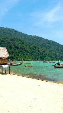 Explore the serene shores of Surin Island in Thailand at the traditional Moken Village, surrounded by breathtaking nature and crystal clear waters. 