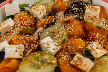 Fresh salad with colorful ingredients and sesame seeds served in a bowl