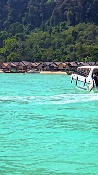 Experience the breathtaking beauty of Surin Island with its shimmering turquoise waters and lush green surroundings.