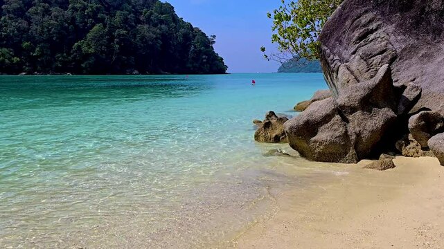 Surin Island in Thailand offers breathtaking views of sparkling turquoise waters, white sandy beaches, and lush green hills. Enjoy a serene escape where nature shines at its best.