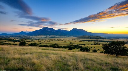 Obraz premium Sunrise Over Rolling Hills and Grassy Plains