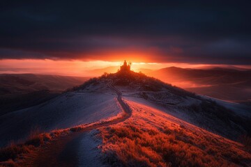 Church on a hill at sunset, with a path leading to it and mountains behind