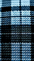 Textured blue plaid fabric showcasing intricate woven patterns in close-up view 