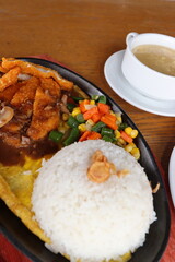 black hotplate rice vegetable fish chicken and meat  dinner with slice fruit