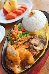 black hotplate rice vegetable fish chicken and meat  dinner with slice fruit