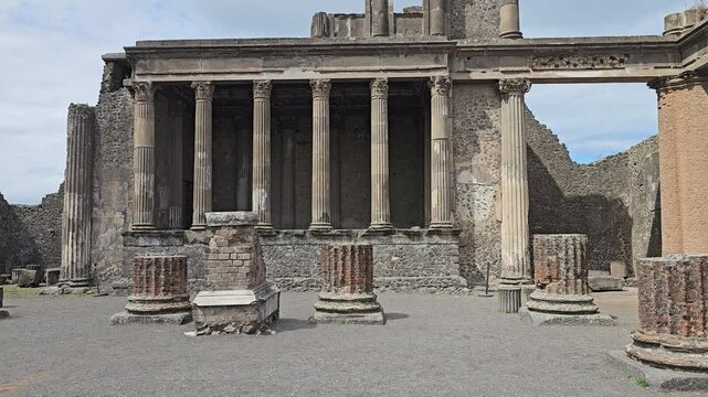Tilt up view of the columns of the Basilica in the ancient ruins of Pompeii, Italy