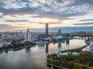 Yekaterinburg city and pond aerial panoramic view at summer or early autumn sunset. Night city in the early autumn or summer.
