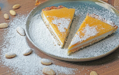 Pieces of cake on a plate of almond flour and natural fruit in kitchen. Nuts on the table. Healthy food and products. Organic ingredients and vegan nutrition. 