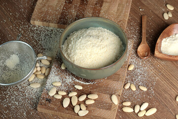 Almond flour in bowl. Nuts on table. Healthy food and products. Organic ingredients and vegan nutrition. 