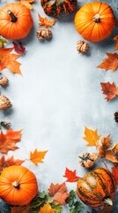 A festive arrangement of pumpkins and autumn leaves on a textured background.