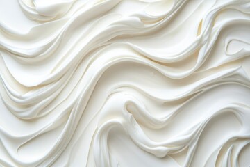 Obraz premium Creamy swirls fill the frame. Background is blurred for dessert or baking uses