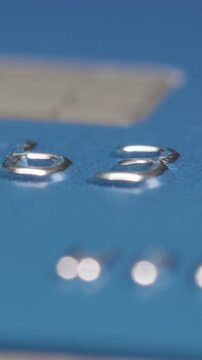 Slider macro shot of a credit cards numbers, vertical