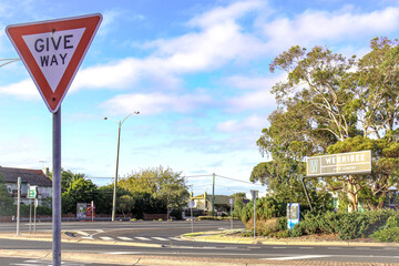 suburban town sign werribee with give way sign in foreground