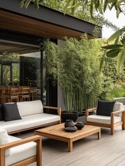 Stylish outdoor patio featuring teak furniture and lush bamboo plants