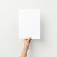 A hand holding up a white blank sheet of paper on a white background 