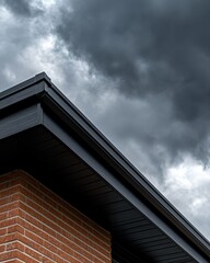 A close-up of a roof's edge against a backdrop of dark, ominous clouds, showcasing modern architectural elements and a hint of impending weather.