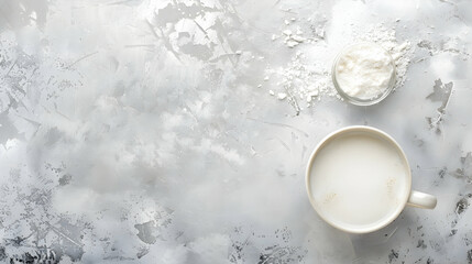 A serene kitchen scene featuring a cup of milk and a bowl of flour on a textured surface, ideal for cooking themes