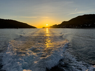 Fabulous sunset of the Gulf of Poets seen from the stern of a boat. Travel from Porto Venere and Lerici in Liguria