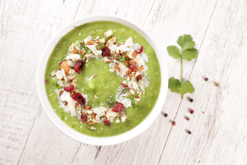  Bowl of Green Vegetable Soup with Cream and Seeds