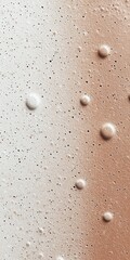 Abstract image featuring textured surfaces with bubbles in a gradient of white and bronze tones.