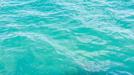 Turquoise ocean water surface, tranquil summer seascape, perfect for tropical vacations and relaxation themes