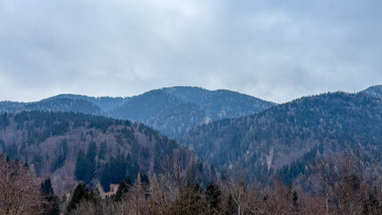 Majestic mountainscape with misty hills and cloudy sky, serene nature, autumn scenery, peaceful retreat