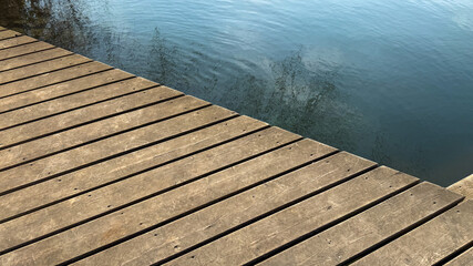 Wooden dock by calm lake, serene natural landscape, peaceful retreat, summer relaxation, tranquil...