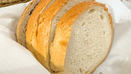 Sliced fresh bread on cloth, perfect for breakfast dining, bakery celebration, cozy homemade meals
