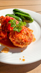 Stuffed peppers with rice and meat, garnished with parsley, summer lunch, homemade comfort food delight
