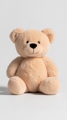 Obraz premium A soft, beige teddy bear sitting upright, designed for comfort and companionship.