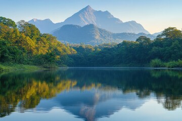 Naklejka premium Majestic mountain reflecting in tranquil river at sunset