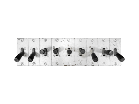 Old eight black toggle switches mounted on a rectangular metal panel is isolated.