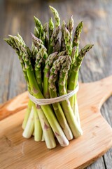 A bunch of fresh green asparagus on wooden table