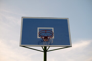 photo of a basketball hoop with a blue backboard
