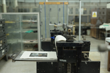 A detailed inked artwork on an intaglio plate at an Etching Press machine, Ready for printing, showcasing the traditional printmaking techniques in a dedicated studio setting