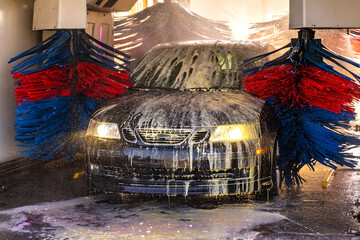 Car going through an automated car wash machine.