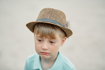 sad boy in a hat on a white background