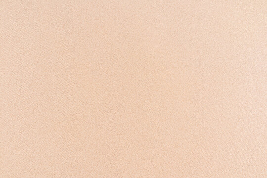 Fototapeta The background image of the fabric texture is beige in a golden hue. layout for design. A copy space. top view. Abstract background of elegant fabric.