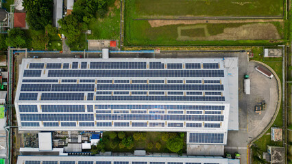 A vast factory rooftop is covered with solar panels, harnessing renewable energy for a greener and...