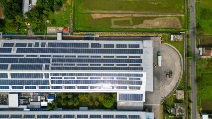 A vast factory rooftop is covered with solar panels, harnessing renewable energy for a greener and...