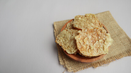 Keripik Tempe or Tempe chips, a typical Indonesian food made from thinly sliced ​​tempeh and then fried using seasoned flour. It's salty and savory. Close up