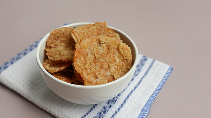 Keripik Tempe or Tempe chips, a typical Indonesian food made from thinly sliced ​​tempeh and then fried using seasoned flour. It's salty and savory. Close up