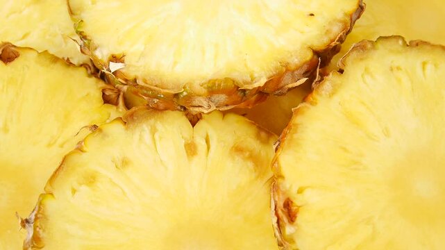 Freshly sliced pineapple on a plate.