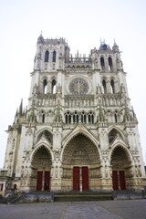 Fototapeta premium Amiens Cathedral front view with Gothic details and red doors