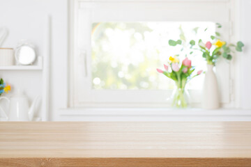 Empty wooden table top with free space on blurred decorated with colorful spring flowers window background
