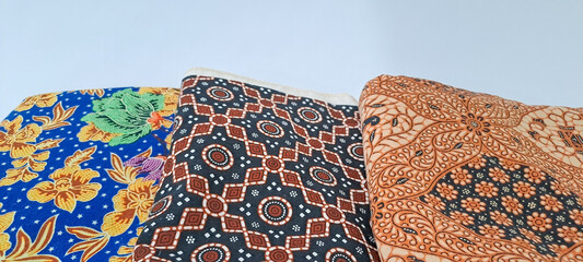 folding jarik or traditional Indonesian batik cloth isolated on white background. Javanese tradisional cloth	

